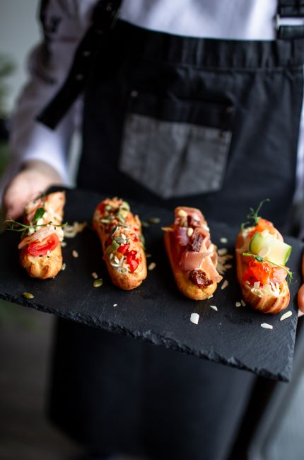 A waiter holding a tray of appetizers